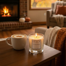 Load image into Gallery viewer, A luxury candle in a clear glass jar with cream-colored wax and a minimalist white label featuring the brand 'STACK' and scent name 'Hiding Place'.